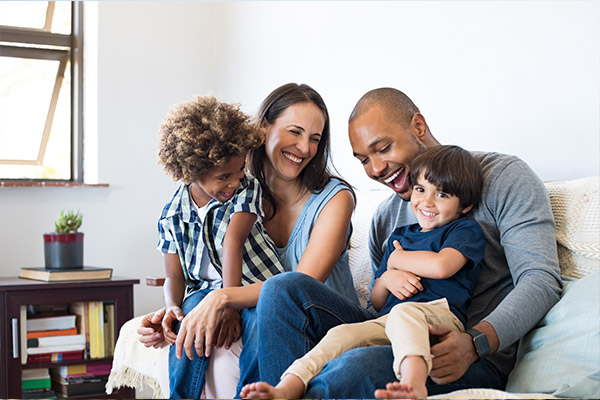 parents and children spending time on the couch Townsend Family Dental Center in Hinesville, GA